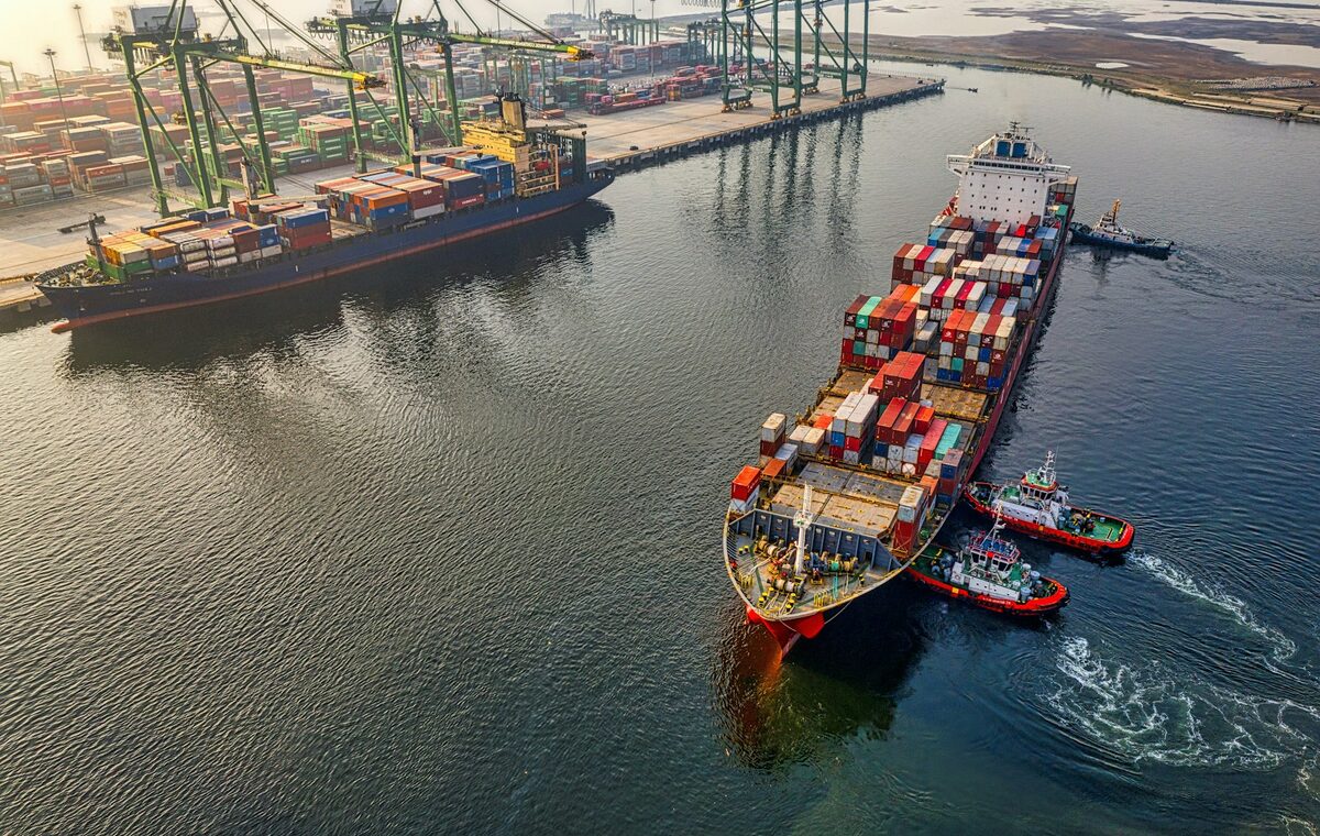 Container ship moving through a working port